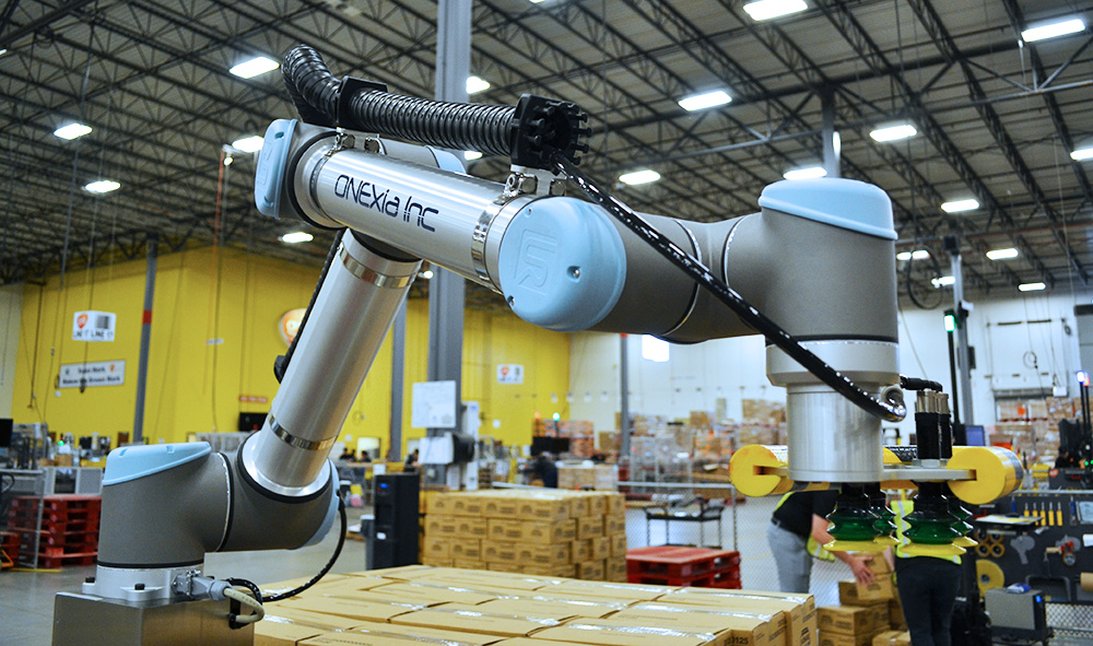 Cobot in manufacturing facility provided by palletizer manufacturers.