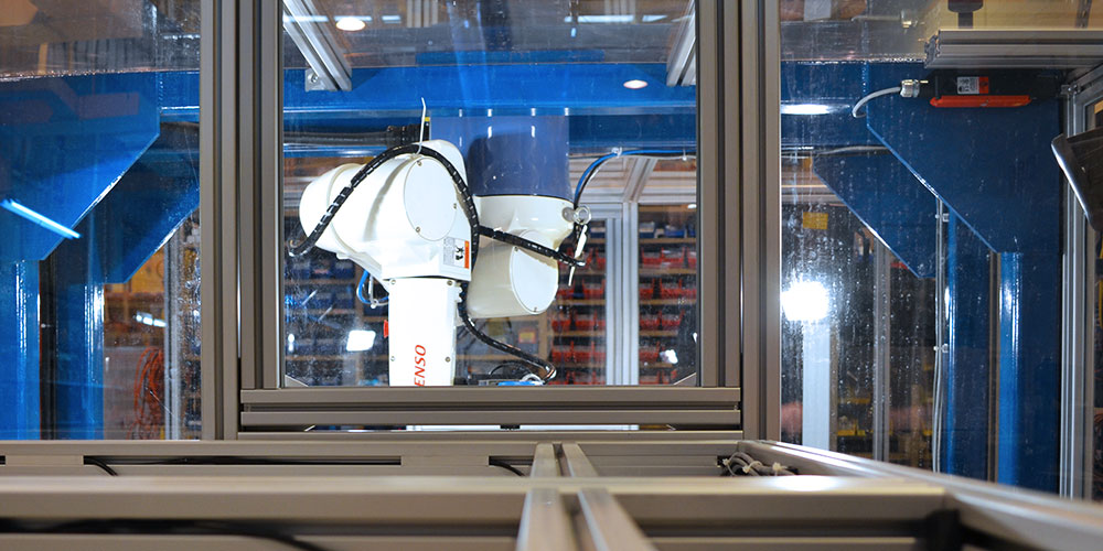 DENSO palletizer robot safely used in manufacturing facility