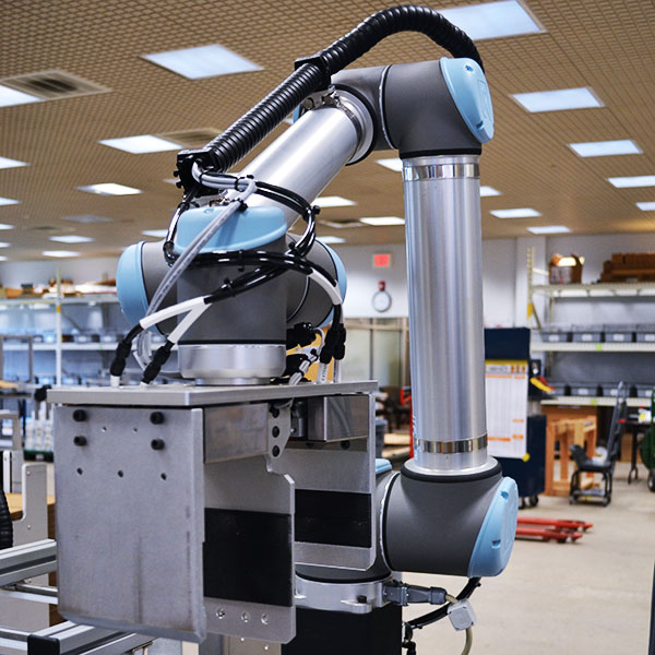 Grey case packing collaborative robot for manual process automation.