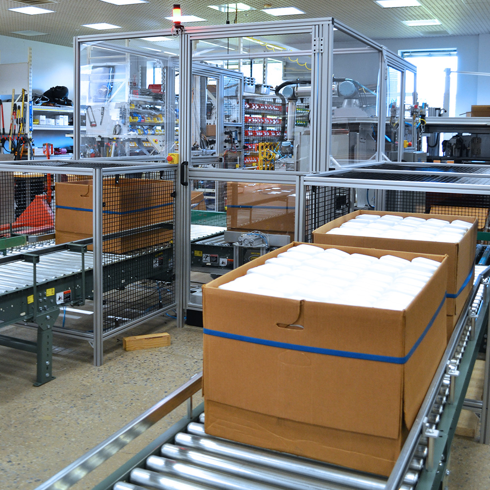 Collaborative robot packing cases in manufacturing manual process automation.