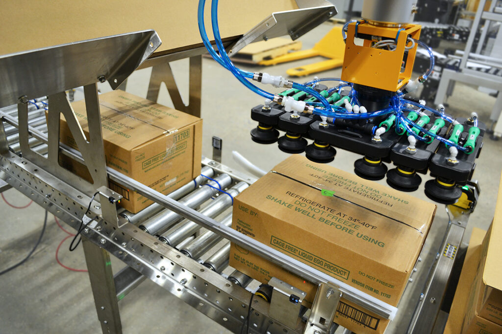 Stainless steel conveyor and slip sheet holder